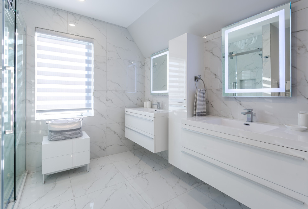 Design ideas for a large contemporary master bathroom in Montreal with flat-panel cabinets, white cabinets, a freestanding tub, a corner shower, a bidet, white tile, porcelain tile, white walls, porcelain floors, an integrated sink, engineered quartz benchtops, white floor, a sliding shower screen, white benchtops, a double vanity and a floating vanity.