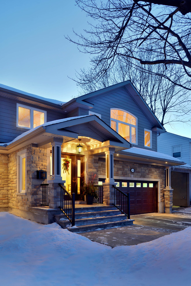 Photo of a mid-sized traditional split-level beige exterior in Ottawa with concrete fiberboard siding and a gable roof.