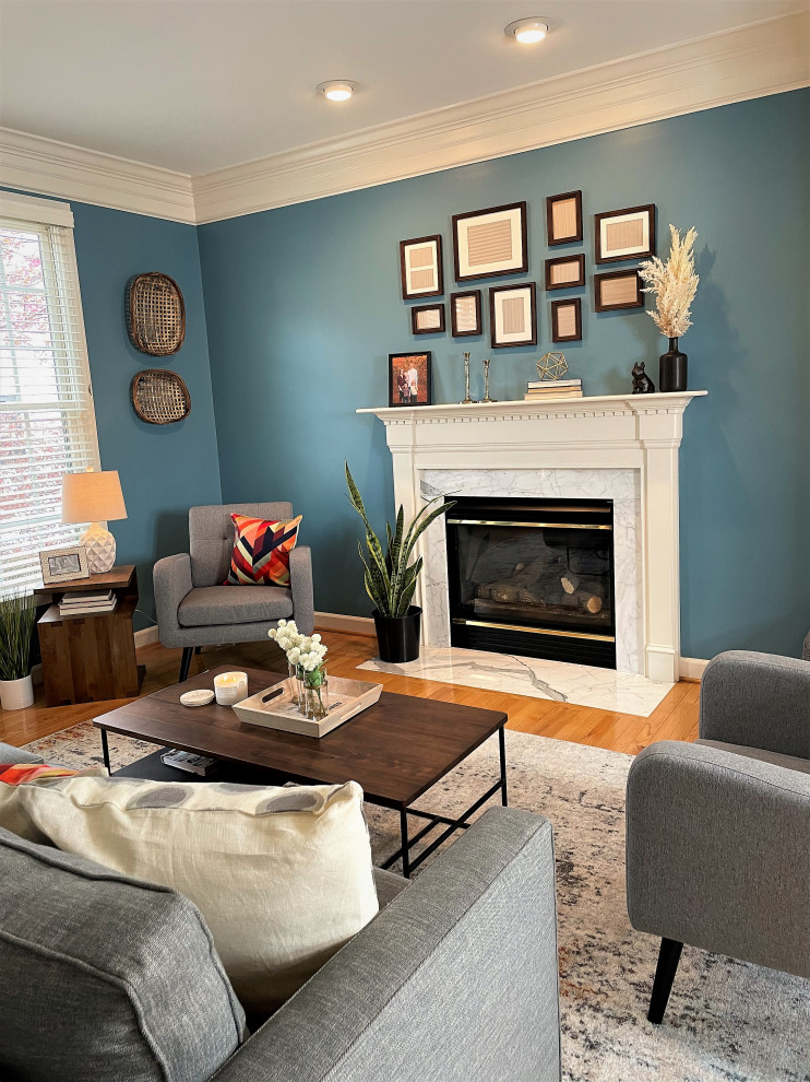 Aménagement d'un salon classique de taille moyenne et ouvert avec un mur bleu, un sol en bois brun et une cheminée standard.