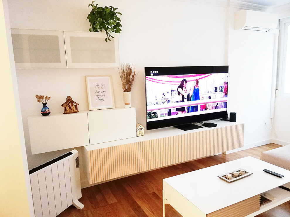 Photo of a small scandinavian open concept living room in Malaga with white walls, medium hardwood floors, no fireplace and a built-in media wall.