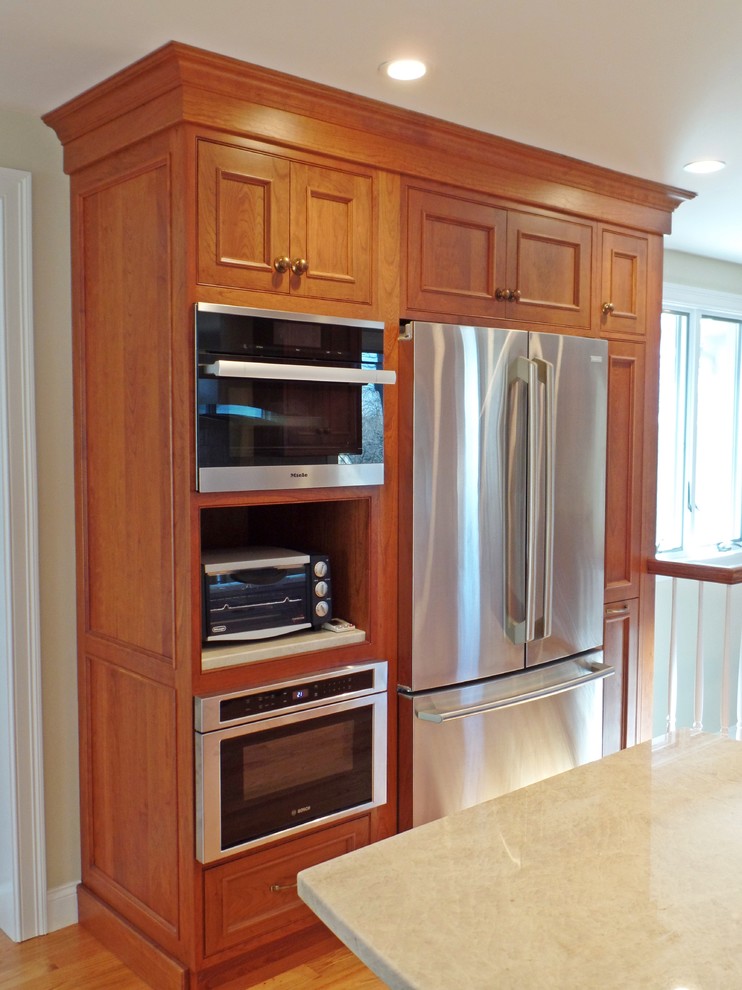 Inspiration for a large transitional l-shaped light wood floor open concept kitchen remodel with a single-bowl sink, beaded inset cabinets, medium tone wood cabinets, quartzite countertops, white backsplash, ceramic backsplash, stainless steel appliances and no island