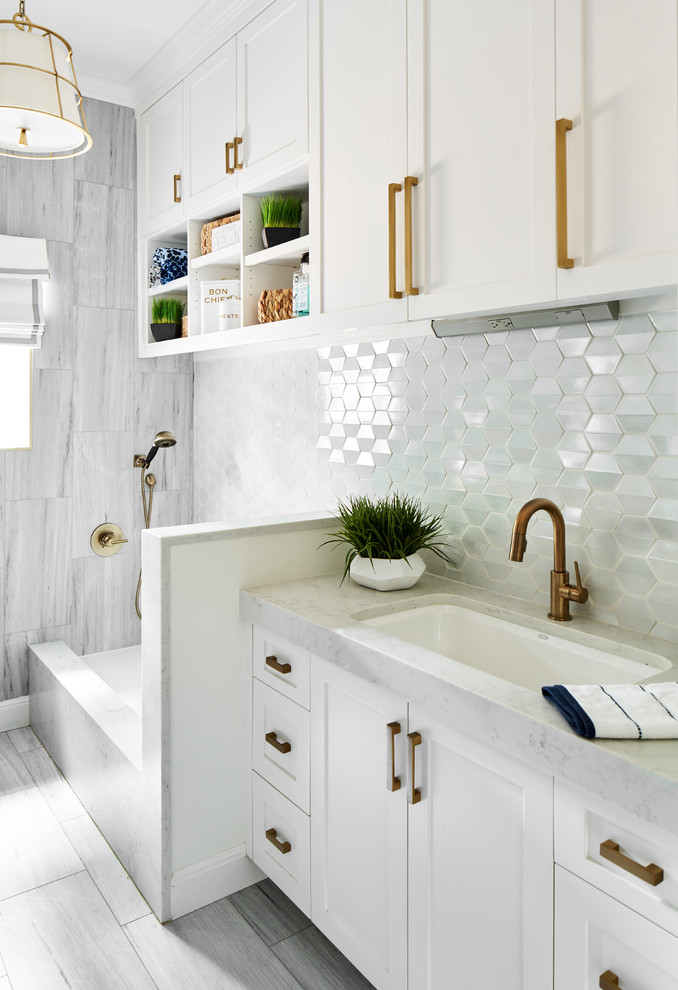 Inspiration for a mid-sized transitional galley porcelain tile and gray floor dedicated laundry room remodel in Austin with an undermount sink, shaker cabinets, white cabinets, quartz countertops, blue walls, a side-by-side washer/dryer and gray countertops