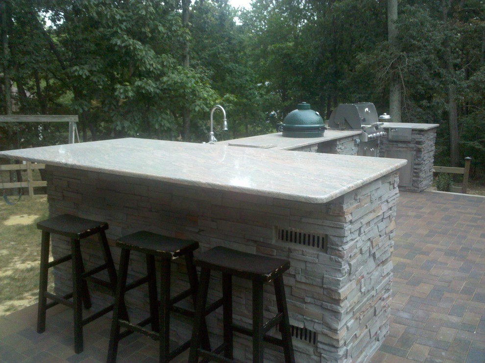 Inspiration for a transitional backyard patio in DC Metro with an outdoor kitchen and concrete pavers.