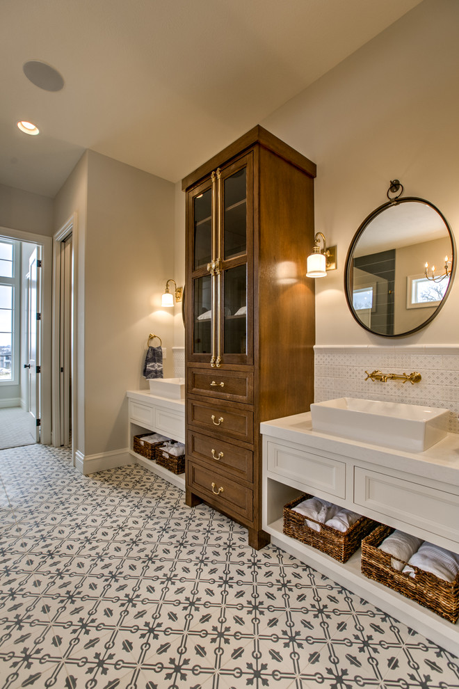 Design ideas for a large country master bathroom in Omaha with recessed-panel cabinets, white cabinets, white tile, grey walls, a vessel sink, multi-coloured floor, white benchtops, ceramic tile and cement tiles.