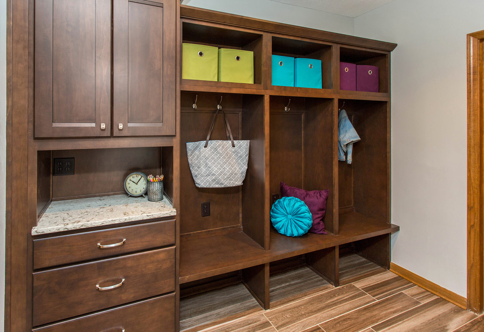 Photo of a mid-sized traditional mudroom in Other with grey walls, ceramic floors and brown floor.
