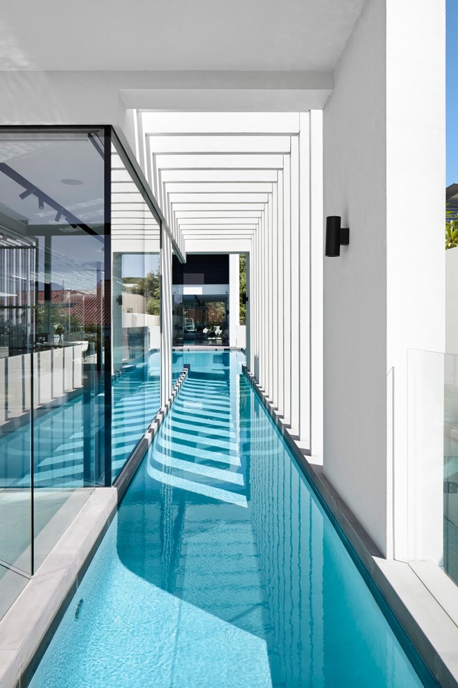 Photo of a large contemporary courtyard l-shaped lap pool in Perth.