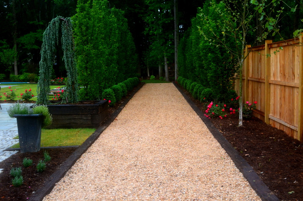 This is an example of a large traditional backyard partial sun formal garden in DC Metro with gravel.