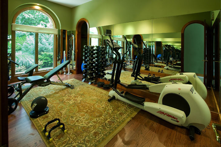 Design ideas for a mid-sized traditional multipurpose gym in New York with green walls and medium hardwood floors.
