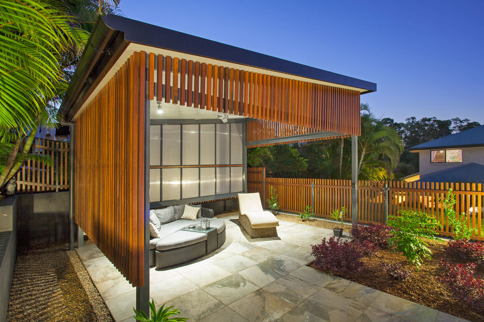 Photo of a mid-sized contemporary backyard kidney-shaped pool in Brisbane with tile.