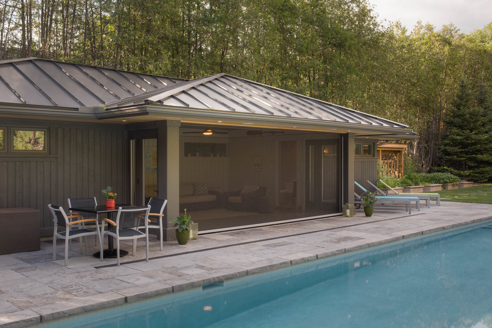 Pool house - large transitional backyard stone and rectangular lap pool house idea