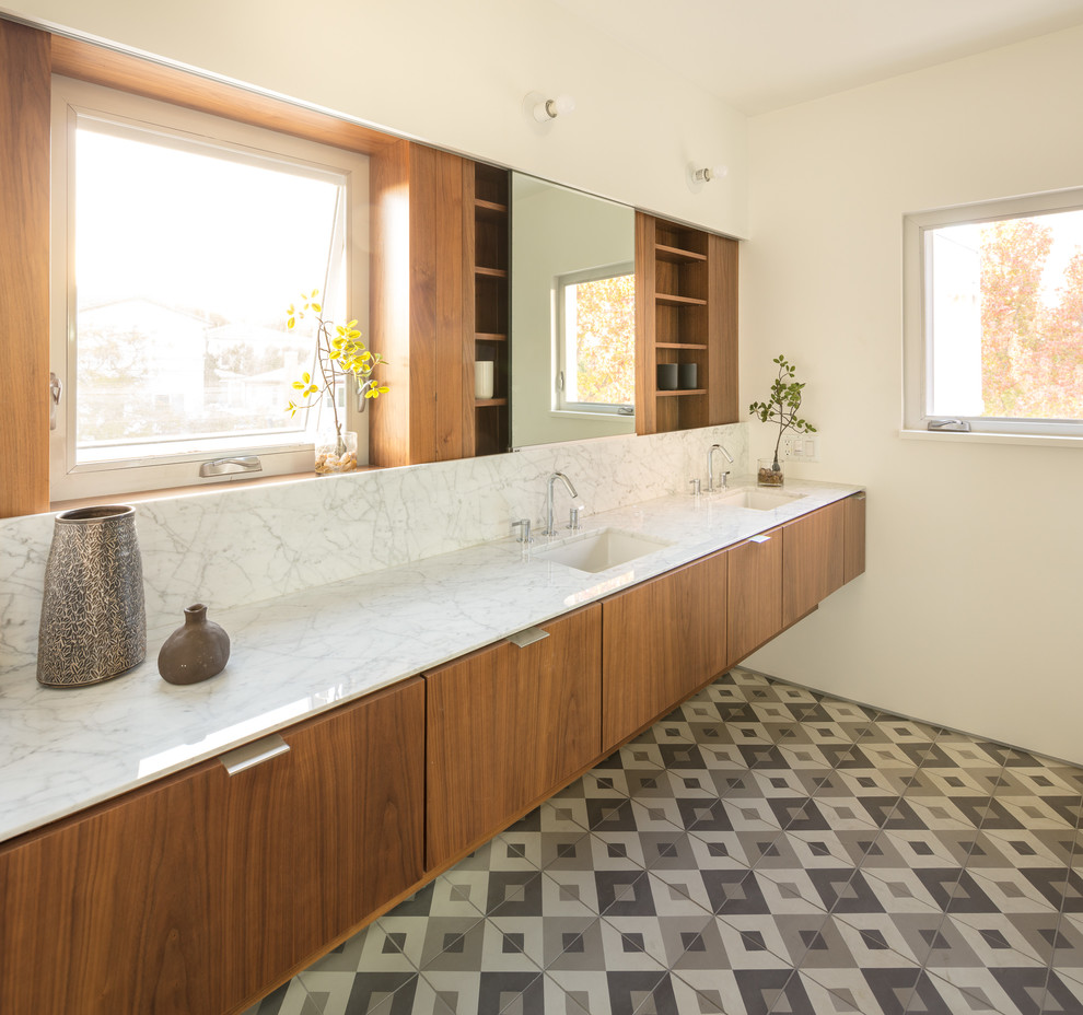 This is an example of a mid-sized modern master bathroom in Los Angeles with flat-panel cabinets, medium wood cabinets, porcelain floors, marble benchtops, grey floor and white benchtops.