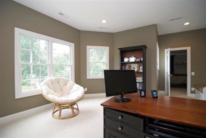 This is an example of a mid-sized traditional study room in DC Metro with brown walls, carpet, no fireplace, a freestanding desk and white floor.