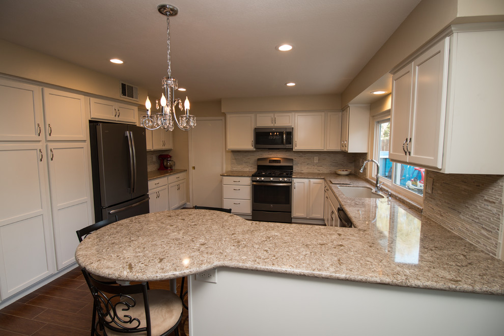 Open concept kitchen - mid-sized transitional u-shaped porcelain tile open concept kitchen idea with an undermount sink, recessed-panel cabinets, beige cabinets, quartz countertops, beige backsplash, mosaic tile backsplash and colored appliances