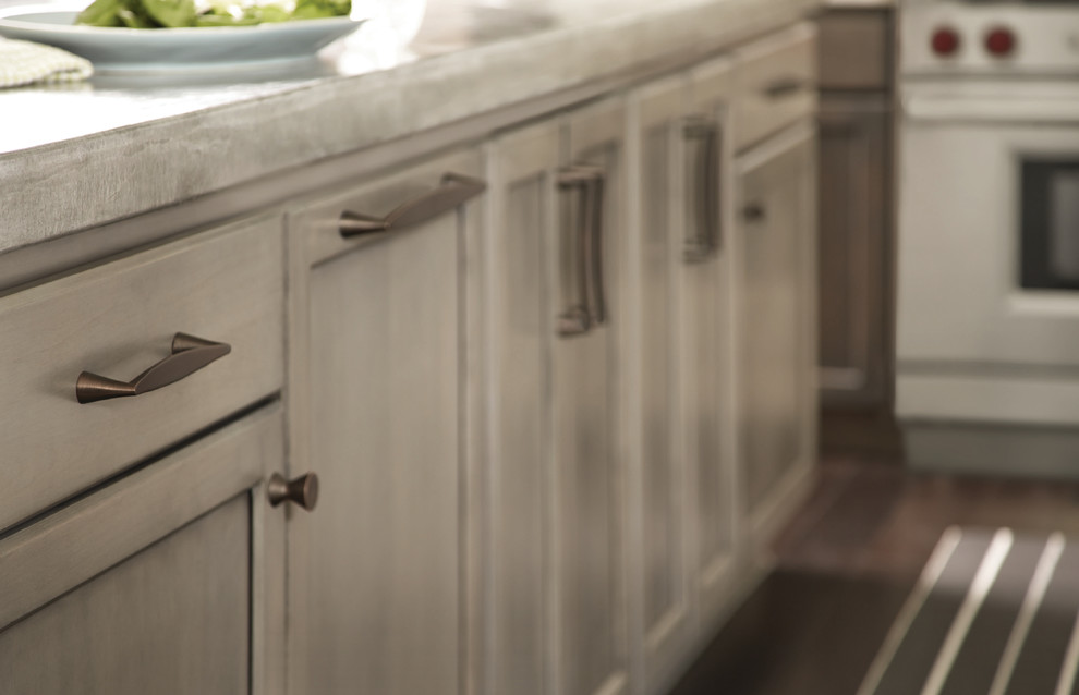Example of a mid-sized mountain style dark wood floor kitchen design in Baltimore with recessed-panel cabinets, gray cabinets, solid surface countertops and stainless steel appliances