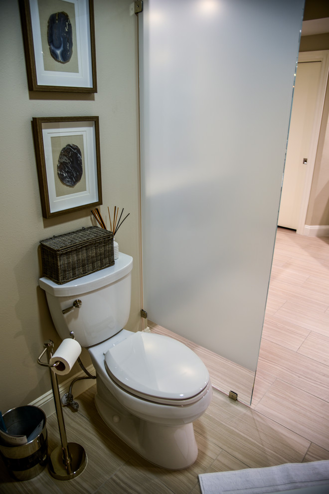 Inspiration for a large transitional powder room in Tampa with raised-panel cabinets, white cabinets, brown tile, porcelain tile, beige walls, porcelain floors, a drop-in sink, granite benchtops and beige floor.