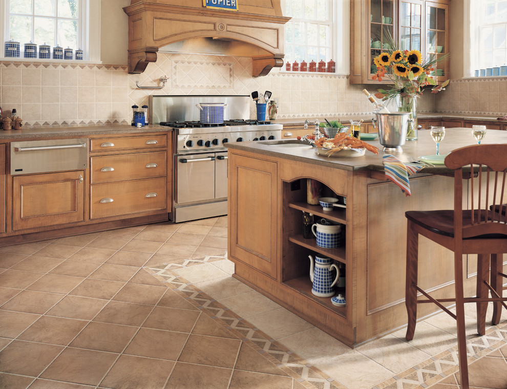 Transitional porcelain tile kitchen photo in Miami with medium tone wood cabinets, beige backsplash, porcelain backsplash, stainless steel appliances and an island