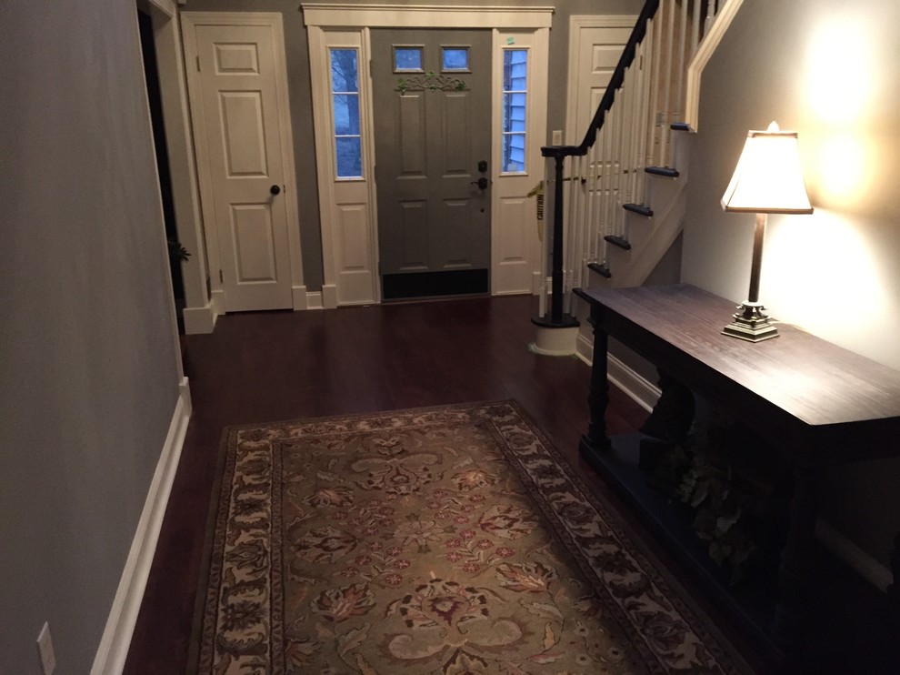 Design ideas for a mid-sized traditional front door in New York with grey walls, dark hardwood floors, a single front door and a gray front door.