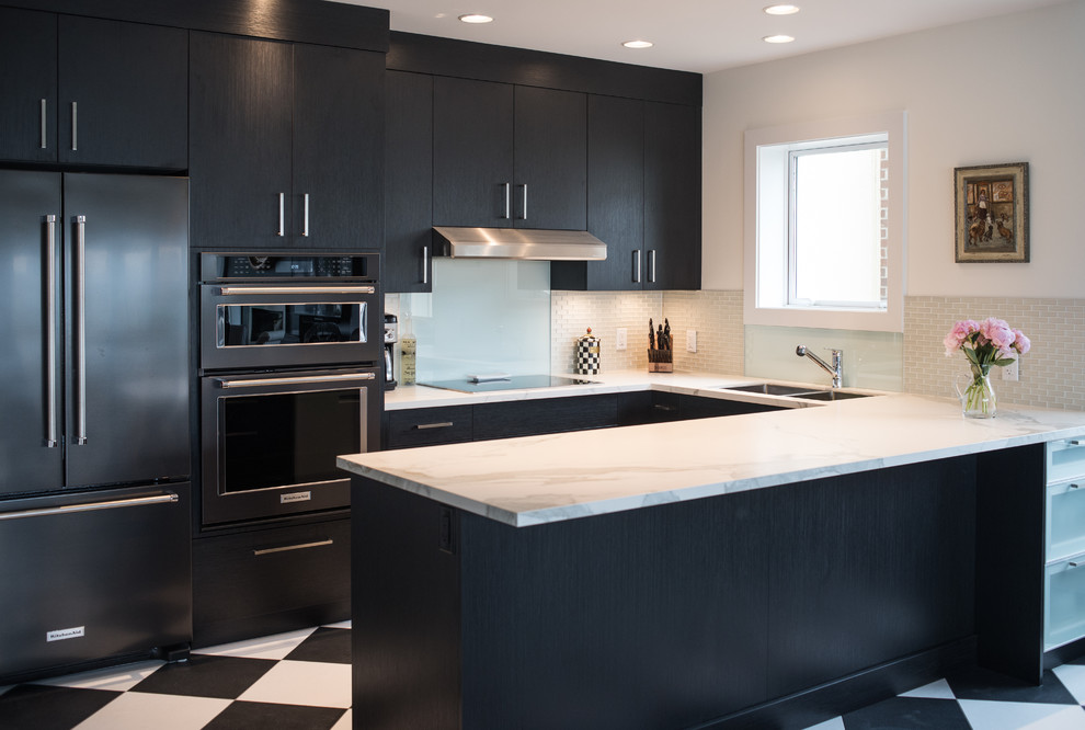 Photo of a small contemporary u-shaped eat-in kitchen in Vancouver with an undermount sink, flat-panel cabinets, black cabinets, glass tile splashback, black appliances, vinyl floors and a peninsula.