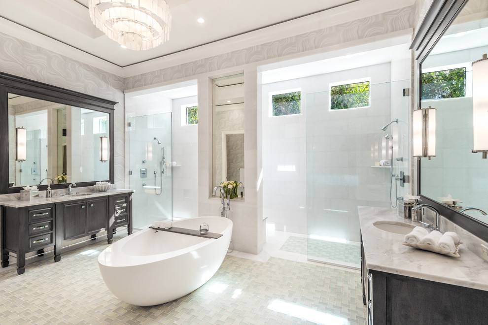 Photo of a transitional master bathroom in Miami with recessed-panel cabinets, black cabinets, a freestanding tub, a double shower, grey walls, mosaic tile floors, an undermount sink, beige floor and an open shower.