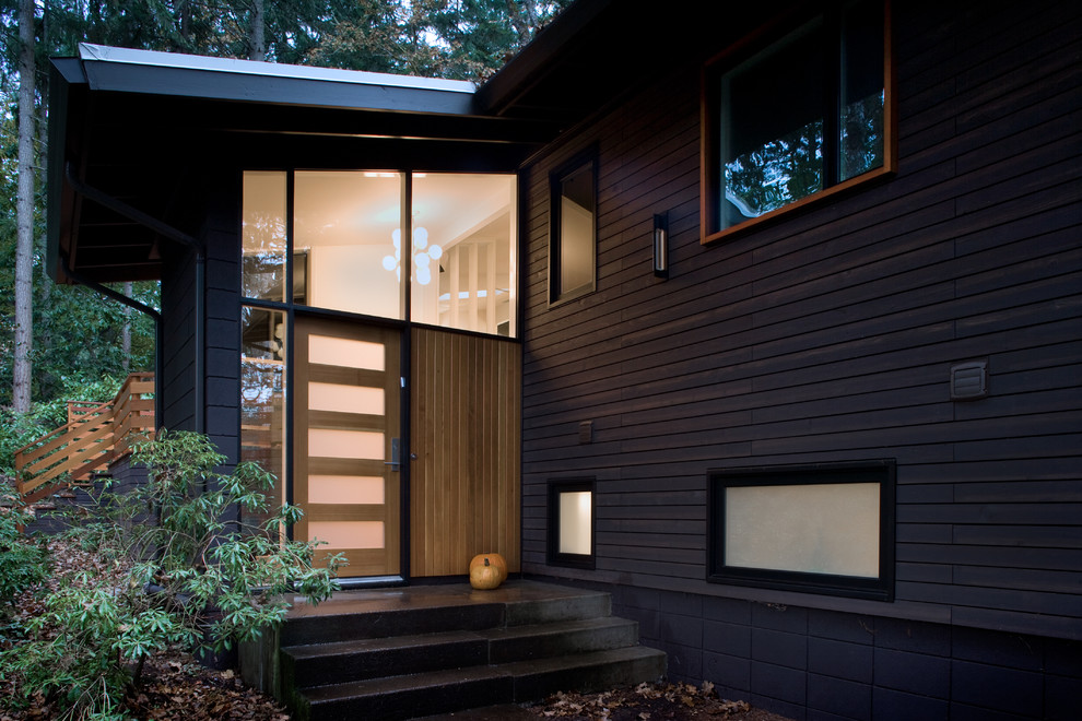 Photo of a mid-sized midcentury front door in Other with a single front door, a glass front door and white walls.