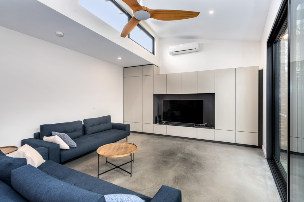 Photo of a large contemporary open concept living room in Melbourne with white walls, concrete floors, no fireplace and a built-in media wall.