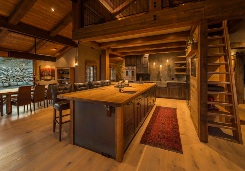 Inspiration for a country l-shaped open plan kitchen in Other with a farmhouse sink, recessed-panel cabinets, dark wood cabinets and with island.