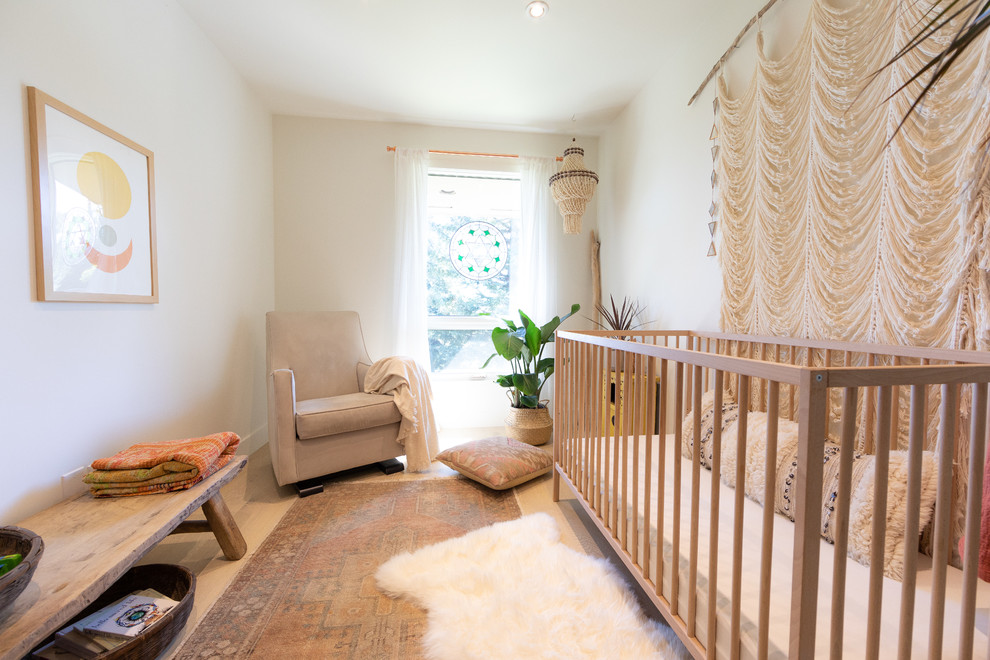 Foto de habitación de bebé neutra escandinava pequeña con paredes blancas, suelo de madera clara y suelo beige