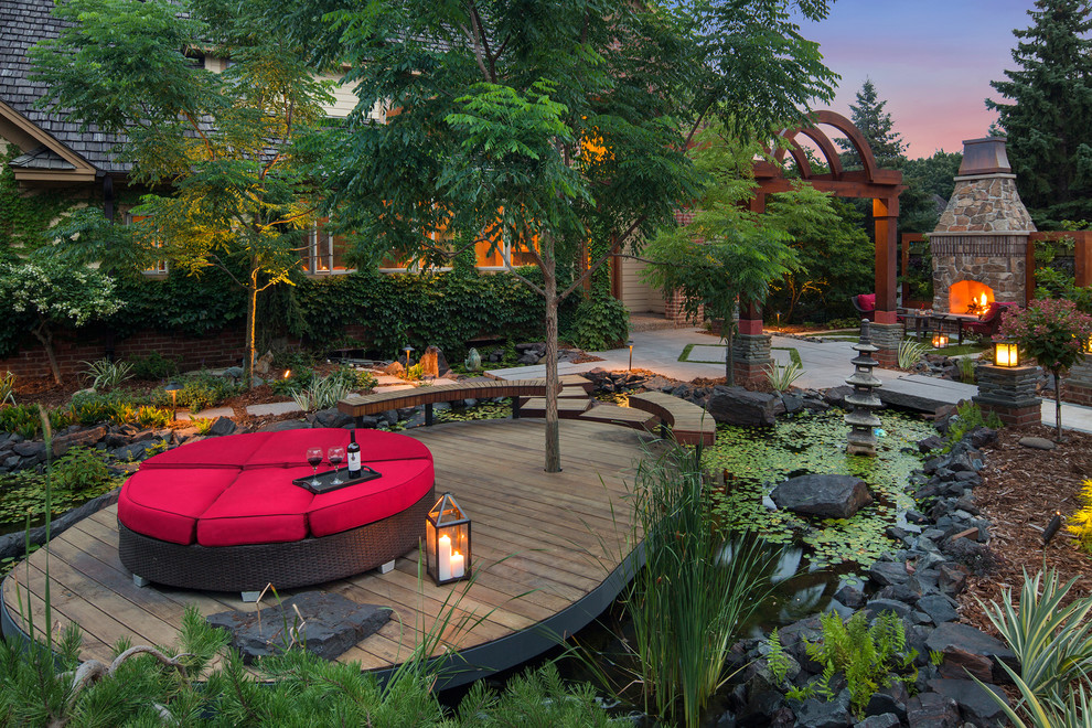 Inspiration for an asian backyard deck in Minneapolis with a water feature and no cover.