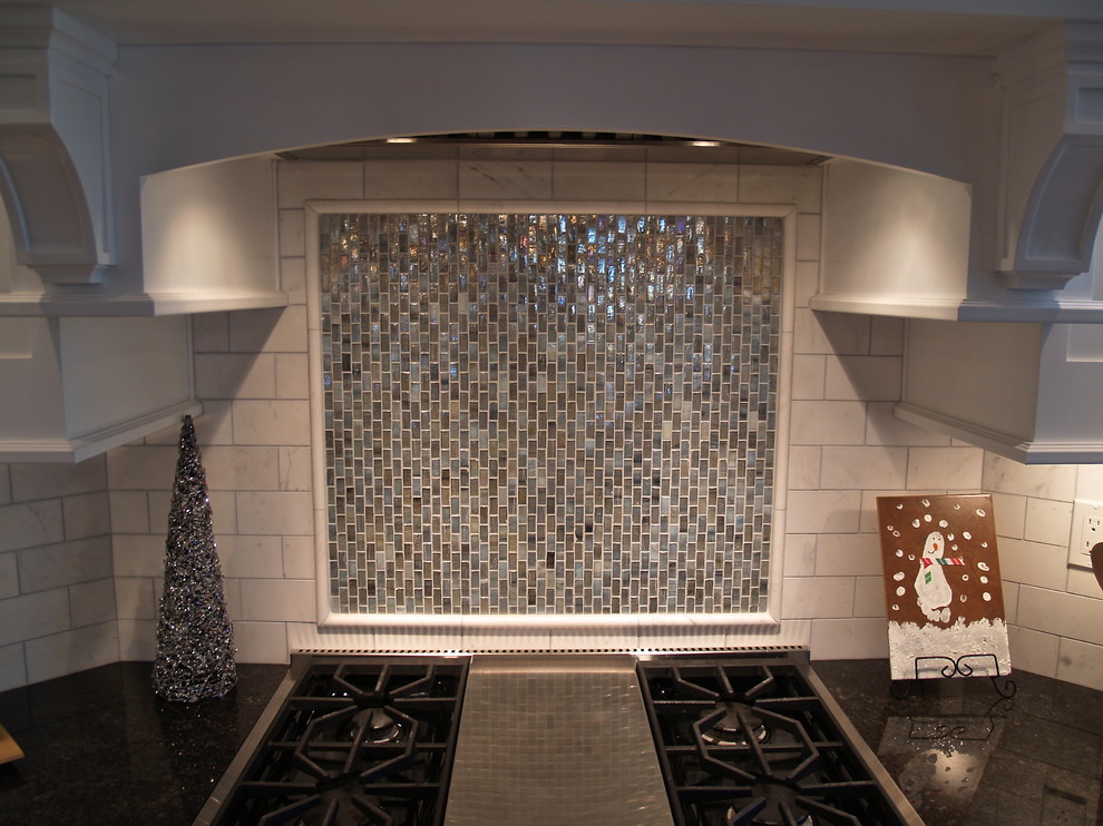 Transitional kitchen photo in Milwaukee with white backsplash, stone tile backsplash, stainless steel appliances and two islands