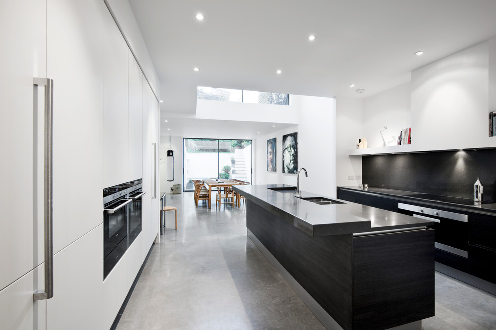 This is an example of a modern kitchen in London with with island.