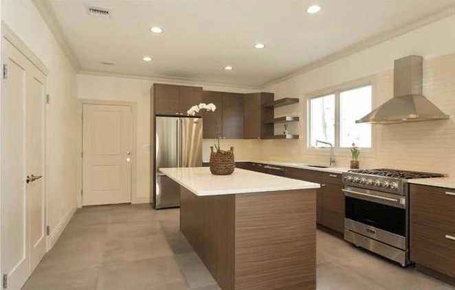 Mid-sized modern l-shaped separate kitchen in New York with an undermount sink, flat-panel cabinets, brown cabinets, quartzite benchtops, white splashback, subway tile splashback, stainless steel appliances, with island, grey floor, concrete floors and white benchtop.