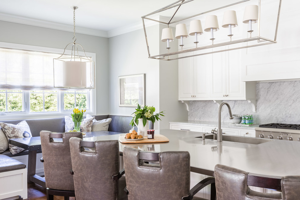 Eat-in kitchen - mid-sized transitional eat-in kitchen idea with a farmhouse sink, gray backsplash, marble backsplash and an island