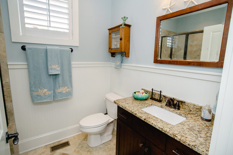 Small arts and crafts 3/4 bathroom in Other with beaded inset cabinets, dark wood cabinets, multi-coloured tile, porcelain tile, blue walls, porcelain floors, an undermount sink and granite benchtops.