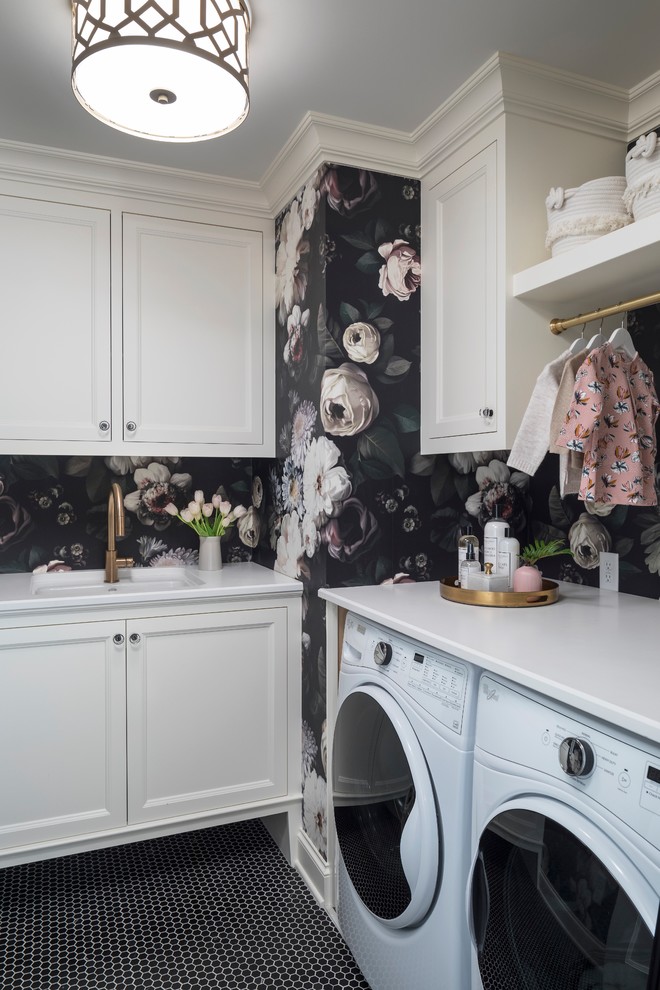 Inspiration for a mid-sized transitional l-shaped dedicated laundry room in Minneapolis with an undermount sink, recessed-panel cabinets, white cabinets, black walls, a side-by-side washer and dryer, black floor, white benchtop, granite benchtops and ceramic floors.