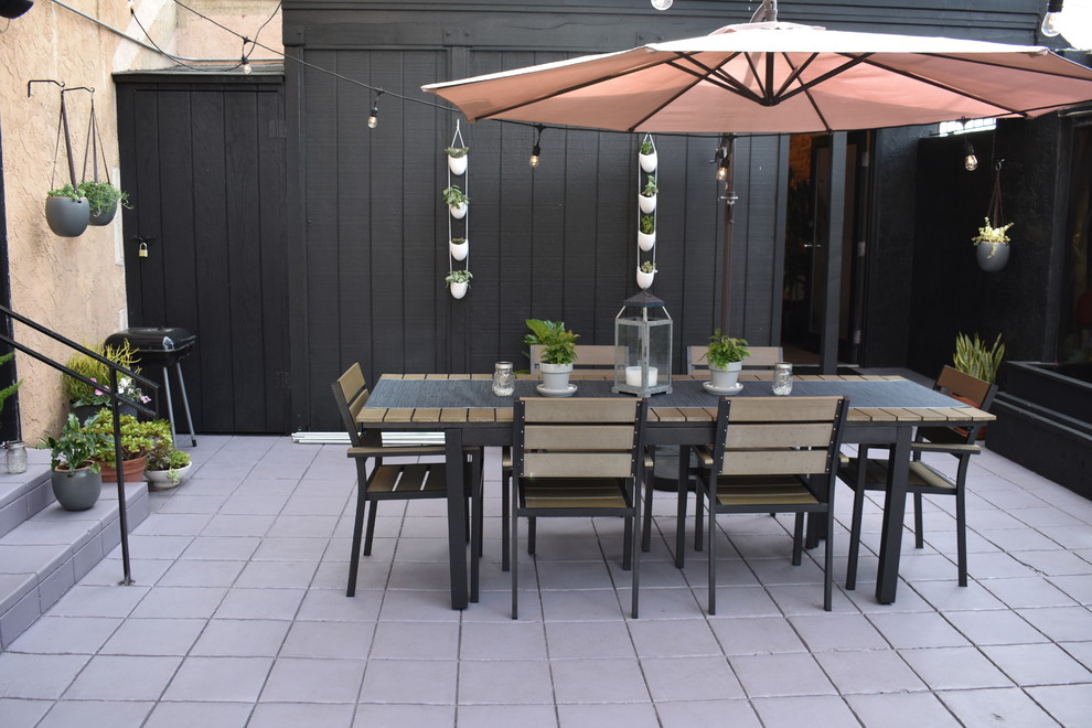 This is an example of a mid-sized contemporary courtyard patio in San Diego with a pergola.