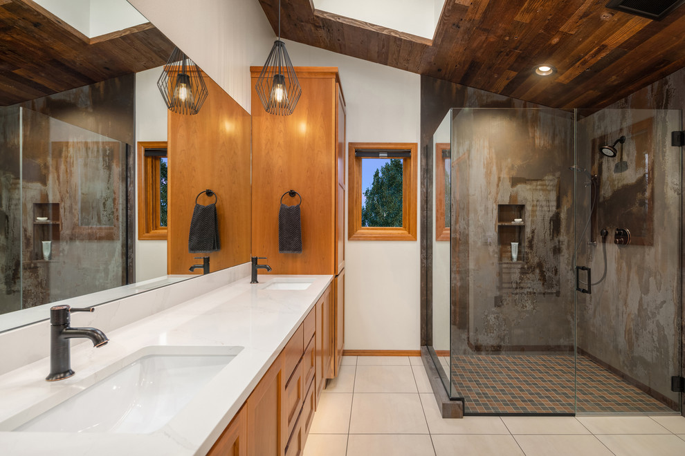 Industrial master bathroom in Seattle with medium wood cabinets, white benchtops, recessed-panel cabinets, a corner shower, white walls, an undermount sink, white floor and a hinged shower door.