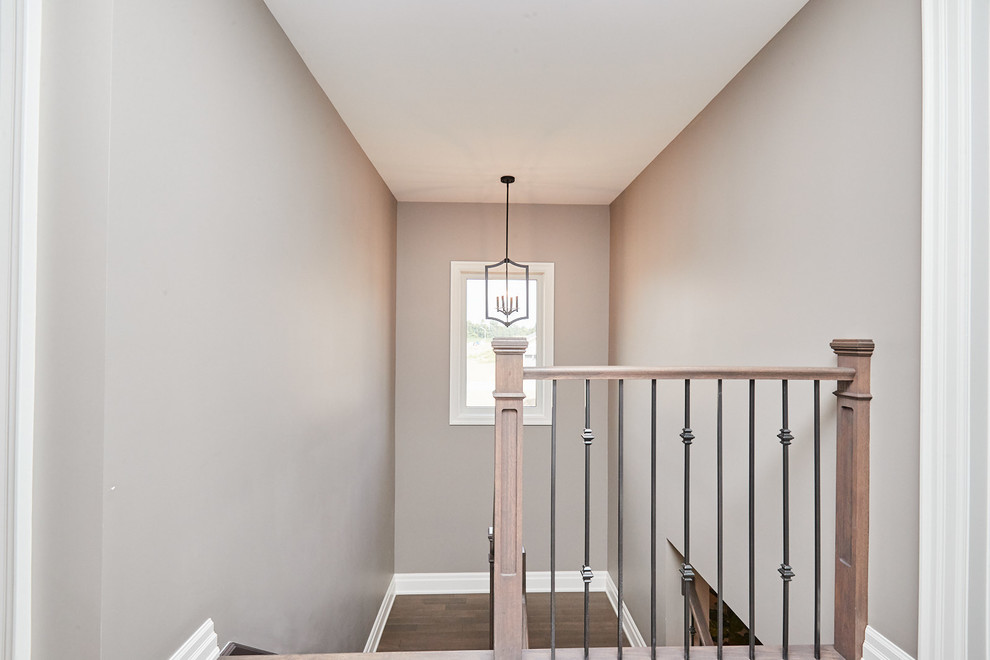 Example of a mid-sized transitional painted metal railing staircase design with painted risers