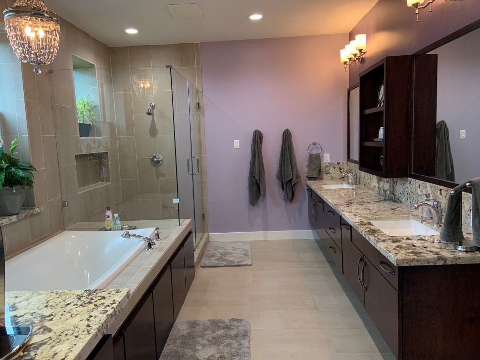 Inspiration for a modern master bathroom in Houston with flat-panel cabinets, brown cabinets, a drop-in tub, beige tile, ceramic tile, purple walls, ceramic floors, an undermount sink, granite benchtops, beige floor, a hinged shower door, a shower seat, a double vanity, a floating vanity and beige benchtops.