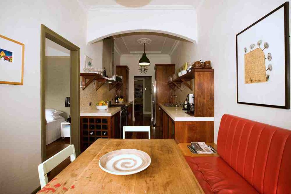 This is an example of a small eclectic galley eat-in kitchen in Brisbane with a double-bowl sink, concrete benchtops, grey splashback, mosaic tile splashback, stainless steel appliances, light hardwood floors, no island, shaker cabinets and dark wood cabinets.