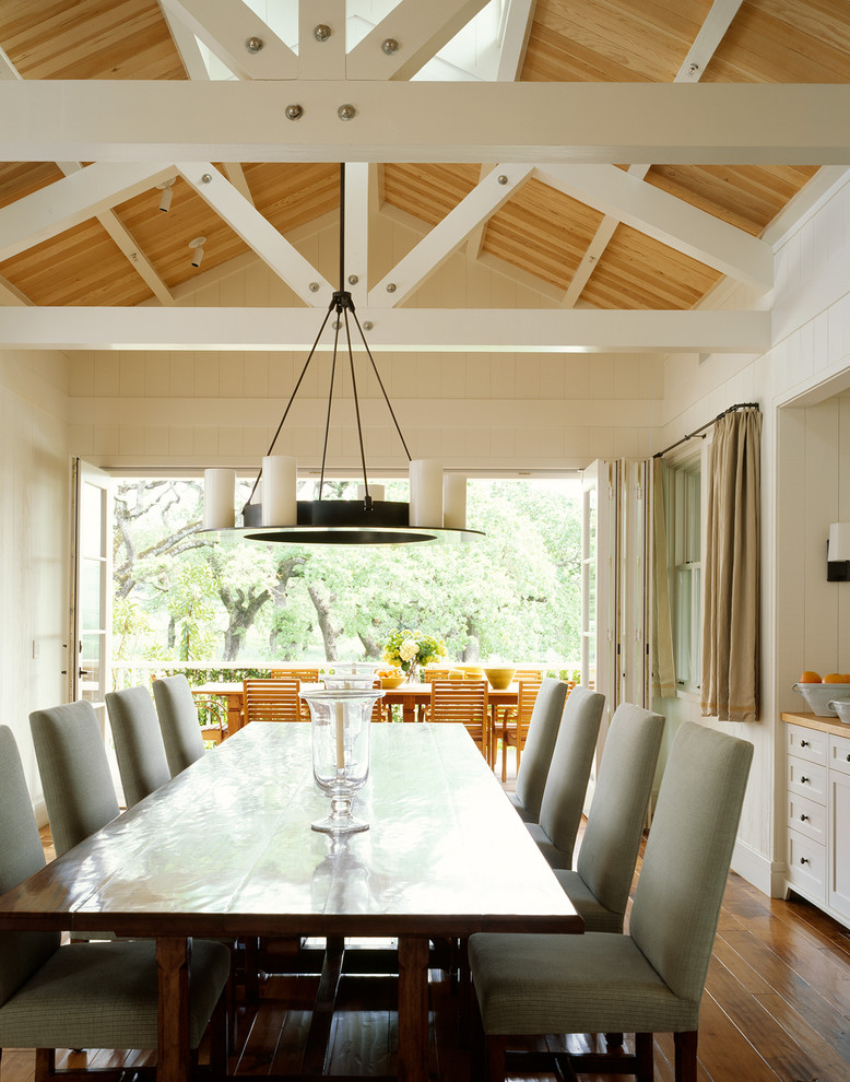 This is an example of a country dining room in San Francisco with white walls and medium hardwood floors.
