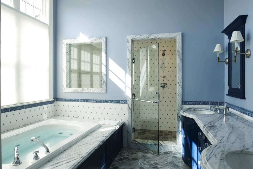 This is an example of a traditional bathroom in New York with an undermount sink, shaker cabinets, blue cabinets, marble benchtops, a drop-in tub, white tile, blue walls and with a sauna.