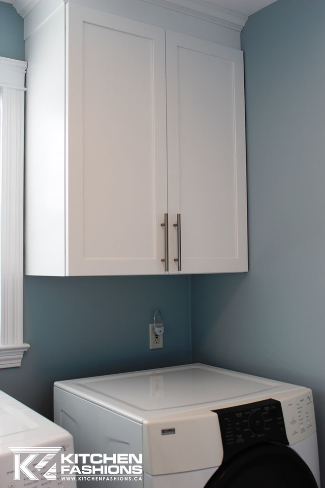 Design ideas for a mid-sized contemporary utility room in Other with an undermount sink, shaker cabinets, white cabinets, quartz benchtops, multi-coloured splashback, blue walls, light hardwood floors and a side-by-side washer and dryer.