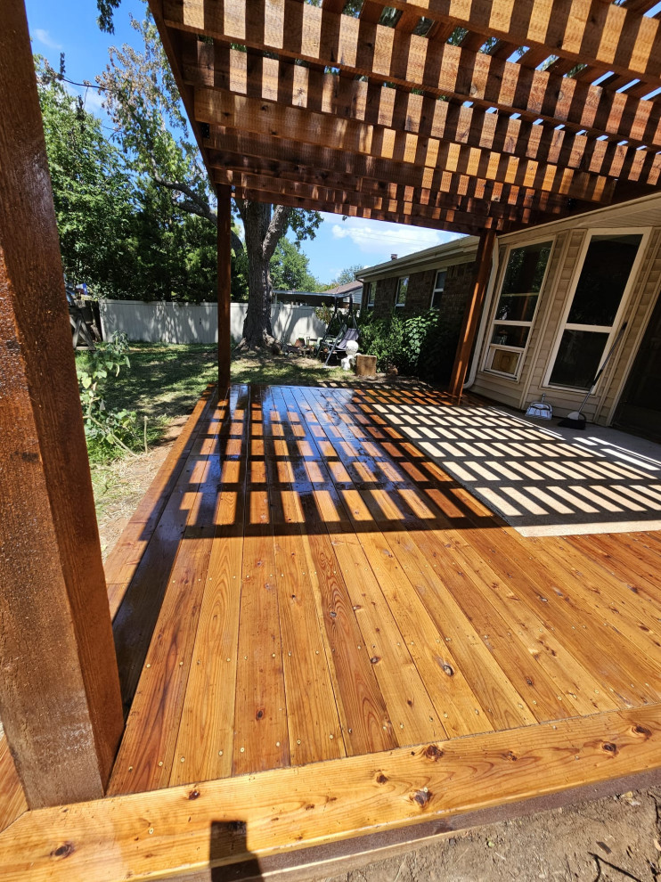 Mid-sized traditional backyard patio in Dallas with a pergola.