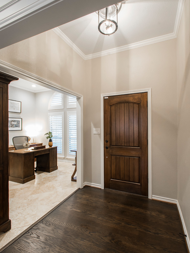 Inspiration for a mid-sized transitional foyer in Dallas with grey walls, medium hardwood floors, a single front door, a dark wood front door and brown floor.