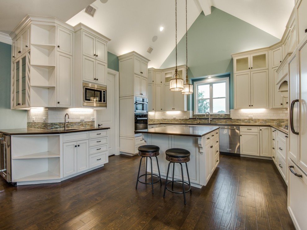 Inspiration for a large transitional medium tone wood floor eat-in kitchen remodel in Dallas with an undermount sink, beaded inset cabinets, white cabinets, quartz countertops, cement tile backsplash, stainless steel appliances and an island