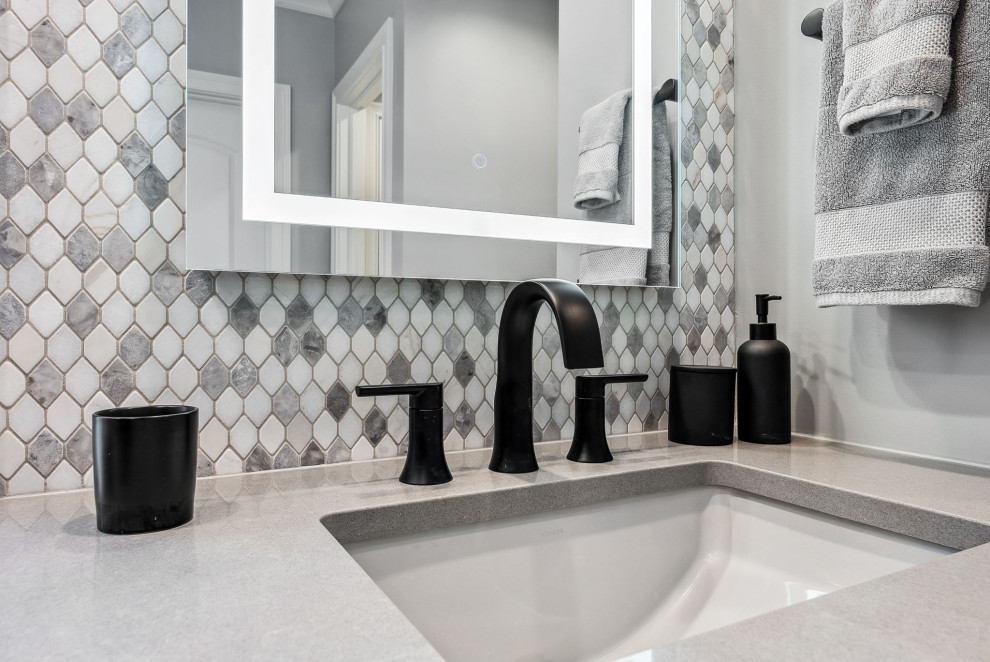 Inspiration for a large transitional master gray tile and mosaic tile porcelain tile, gray floor, double-sink and tray ceiling double shower remodel in Columbus with recessed-panel cabinets, dark wood cabinets, gray walls, an undermount sink, quartz countertops, a hinged shower door, gray countertops, a niche and a built-in vanity
