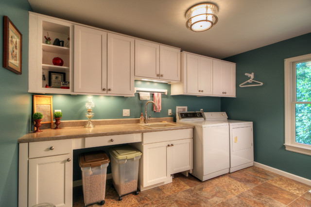 Utility room - large contemporary single-wall ceramic floor utility room idea in St Louis with a drop-in sink, recessed-panel cabinets, white cabinets, onyx countertops, blue walls and a side-by-side washer/dryer
