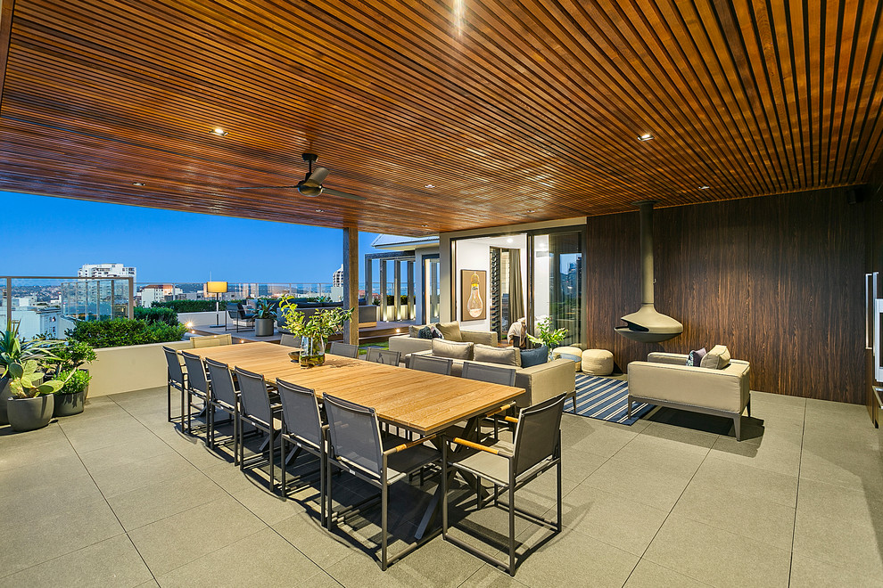 Large contemporary courtyard patio in Sydney with an outdoor kitchen, brick pavers and a pergola.