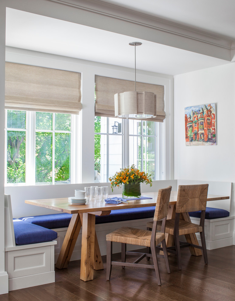 This is an example of a mid-sized traditional dining room in Boston with medium hardwood floors and white walls.