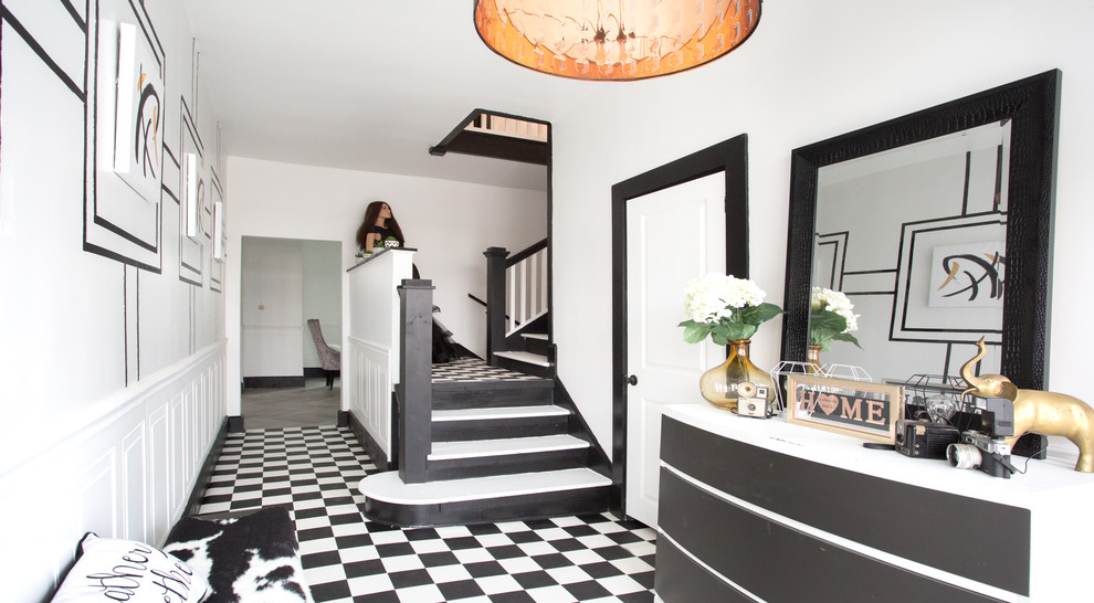 Inspiration for a mid-sized transitional vinyl floor foyer remodel with white walls and a black front door